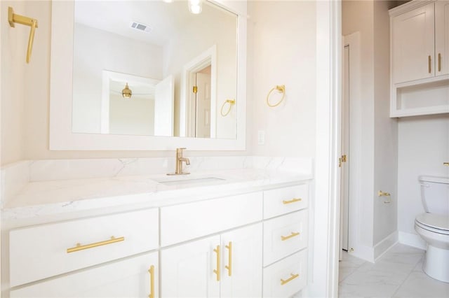 5914 SW Bloomsbury Rd, Bentonville, AR 72713 - bathroom featuring toilet, marble look tile flooring, vanity, and baseboards