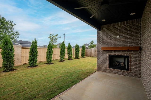 5914 SW Bloomsbury Rd, Bentonville, AR 72713 - view of yard featuring an outdoor brick fireplace, ceiling fan, and a patio area