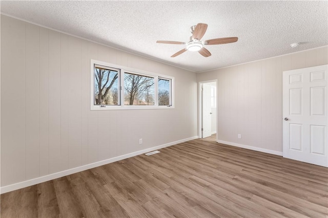 12 Ipswich Dr, Bella Vista, AR 72714 - empty room with a textured ceiling, a ceiling fan, and wood finished floors