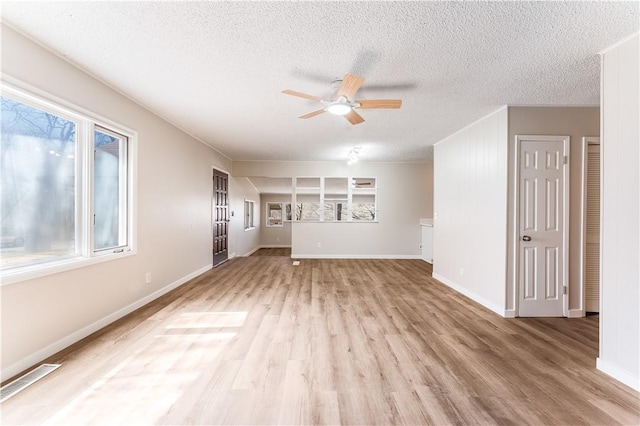 12 Ipswich Dr, Bella Vista, AR 72714 - unfurnished living room with a ceiling fan, light wood-type flooring, and a textured ceiling