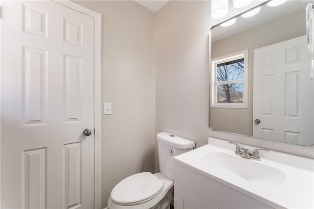 12 Ipswich Dr, Bella Vista, AR 72714 - half bathroom featuring vanity and toilet