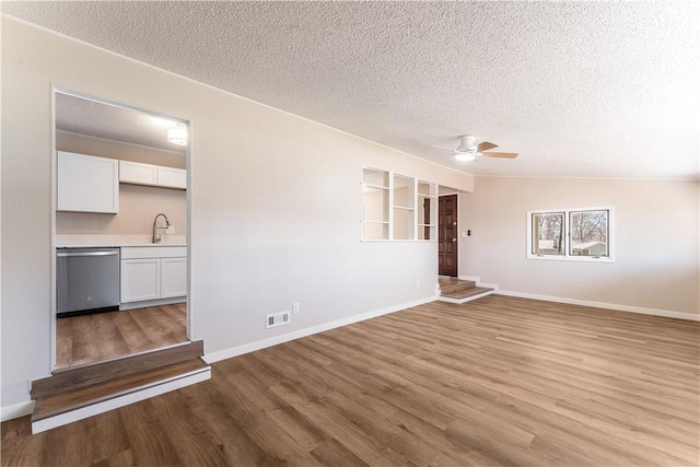 12 Ipswich Dr, Bella Vista, AR 72714 - unfurnished room with a textured ceiling, light wood-style floors, and ceiling fan