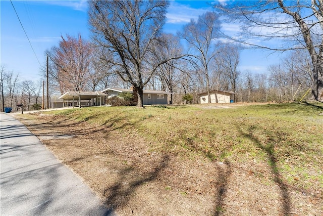 12 Ipswich Dr, Bella Vista, AR 72714 - view of green lawn featuring a carport and driveway