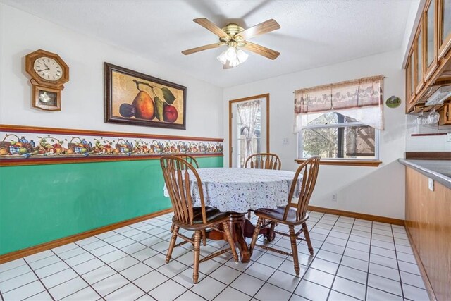 14745 Russell Rd, Siloam Springs, AR 72761 - dining room with ceiling fan, baseboards, and light tile patterned floors