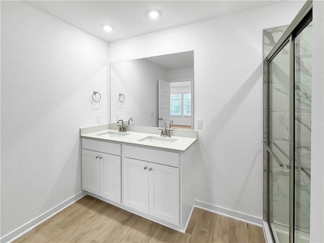 575 W Canada Dr, Farmington, AR 72730 - bathroom with double vanity, a sink, and wood finished floors