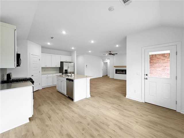 575 W Canada Dr, Farmington, AR 72730 - kitchen featuring ceiling fan, light wood-type flooring, open floor plan, stainless steel appliances, and white cabinetry