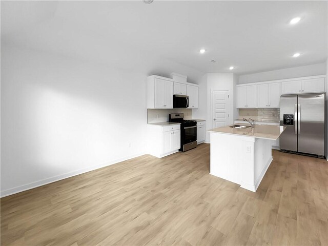 575 W Canada Dr, Farmington, AR 72730 - kitchen with light wood-style floors, white cabinets, stainless steel appliances, and recessed lighting