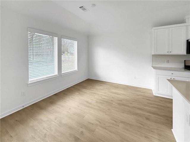 575 W Canada Dr, Farmington, AR 72730 - unfurnished dining area with light wood-style floors, baseboards, and visible vents