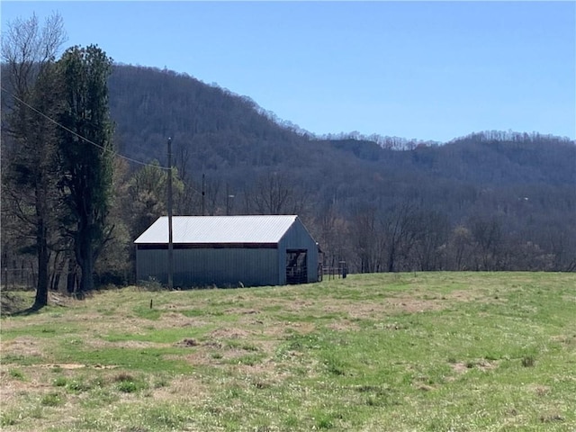 property view of mountains featuring a rural view and a view of trees