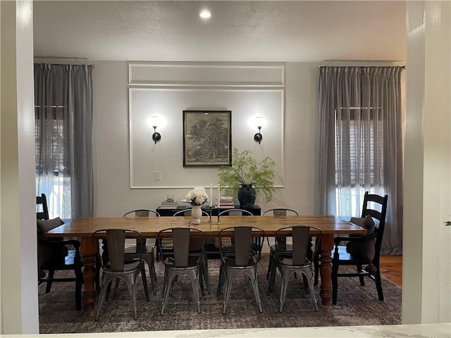 dining area with wood finished floors and plenty of natural light