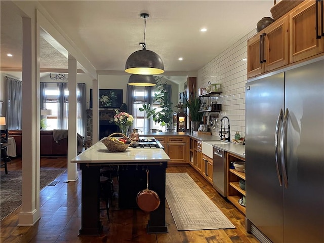 kitchen featuring a sink, a center island, open shelves, and stainless steel appliances