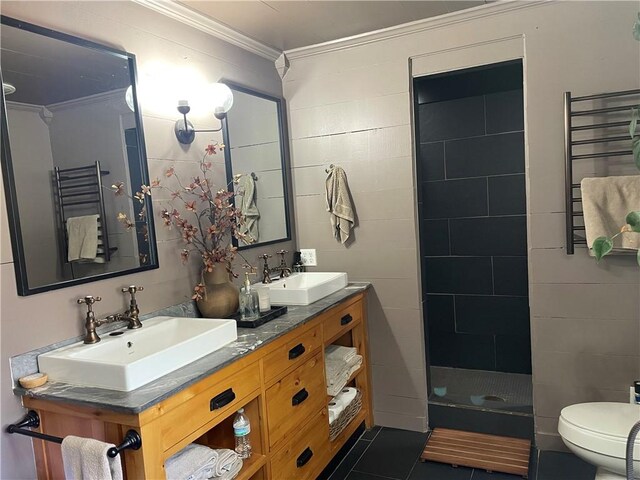 bathroom with toilet, crown molding, radiator, and a sink