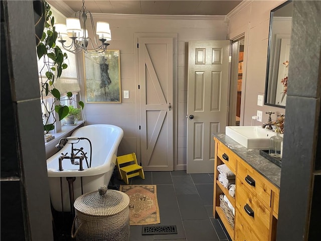 bathroom with crown molding, a soaking tub, an inviting chandelier, vanity, and tile patterned floors