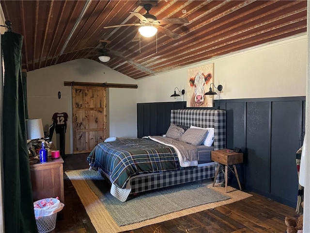 bedroom featuring a barn door, wood ceiling, lofted ceiling, and wood finished floors