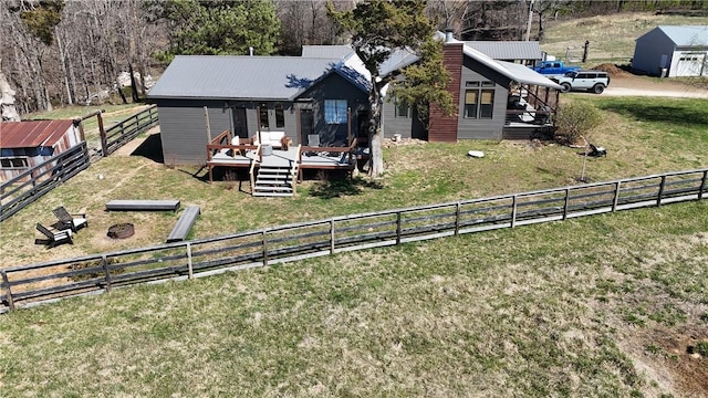 exterior space featuring a front yard, fence, and a wooden deck