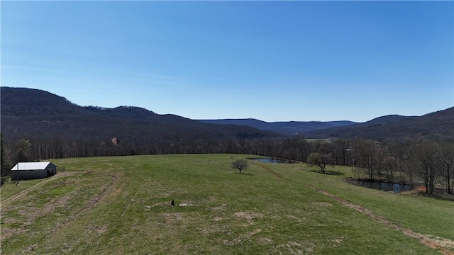 view of mountain feature featuring a water view and a rural view