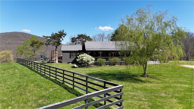 view of yard featuring a mountain view and fence