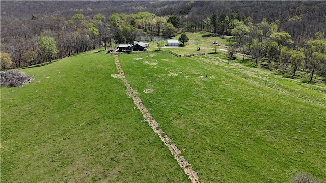 birds eye view of property with a rural view and a wooded view