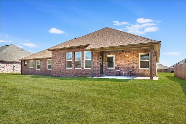 2208 N Carl St, Siloam Springs, AR 72761 - rear view of house featuring brick siding, a patio area, a yard, and roof with shingles