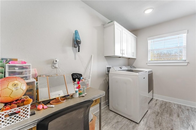 2208 N Carl St, Siloam Springs, AR 72761 - laundry area featuring light wood finished floors, washer and dryer, cabinet space, and baseboards