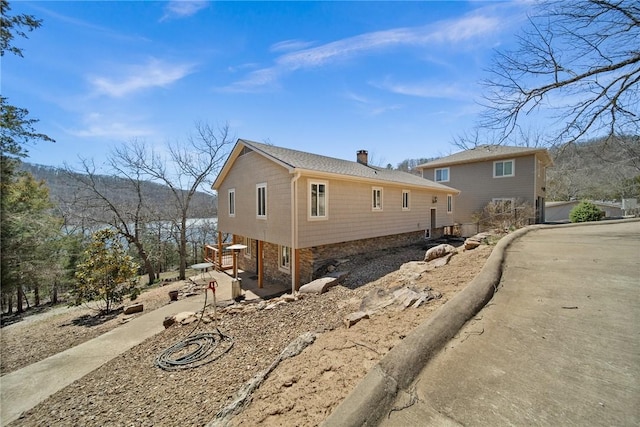 21621 Vista Shores Dr, Garfield, AR 72732 - view of side of home with stone siding, a patio, and a chimney