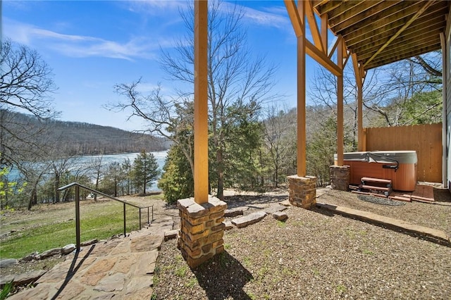 21621 Vista Shores Dr, Garfield, AR 72732 - view of yard featuring a forest view, a water view, fence, and a hot tub