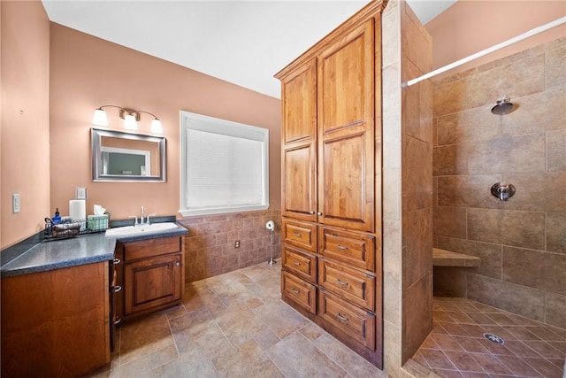 21621 Vista Shores Dr, Garfield, AR 72732 - bathroom featuring tiled shower, tile walls, and vanity