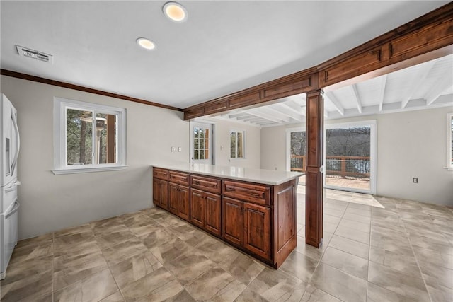 21621 Vista Shores Dr, Garfield, AR 72732 - kitchen with visible vents, beamed ceiling, light countertops, ornamental molding, and a peninsula