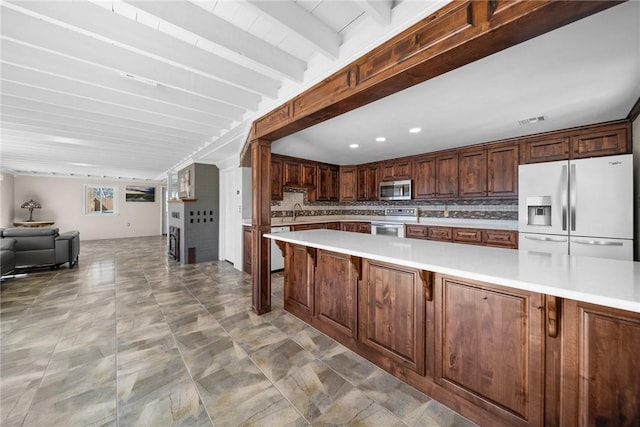 21621 Vista Shores Dr, Garfield, AR 72732 - kitchen with white appliances, visible vents, light countertops, tasteful backsplash, and open floor plan