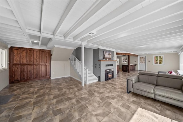 21621 Vista Shores Dr, Garfield, AR 72732 - unfurnished living room featuring a large fireplace, beam ceiling, a healthy amount of sunlight, and stairs