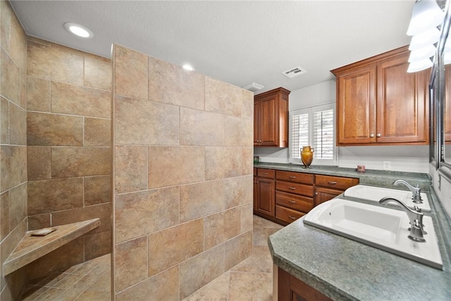21621 Vista Shores Dr, Garfield, AR 72732 - kitchen with dark countertops, visible vents, recessed lighting, brown cabinets, and a sink