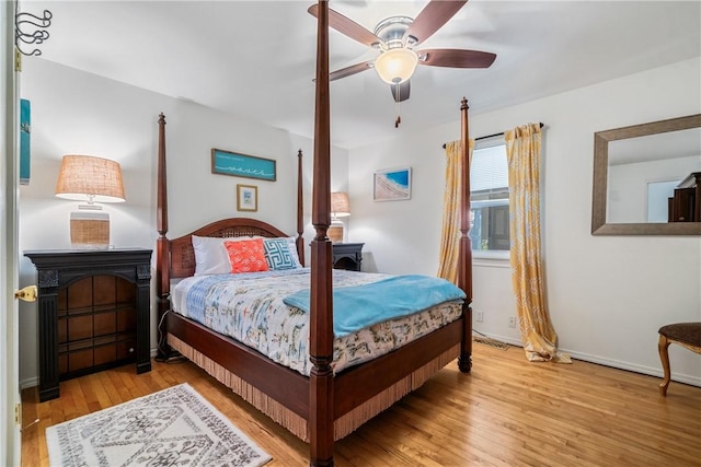 10230 S Marango Dr, Rogers, AR 72758 - bedroom featuring wood finished floors, baseboards, and ceiling fan