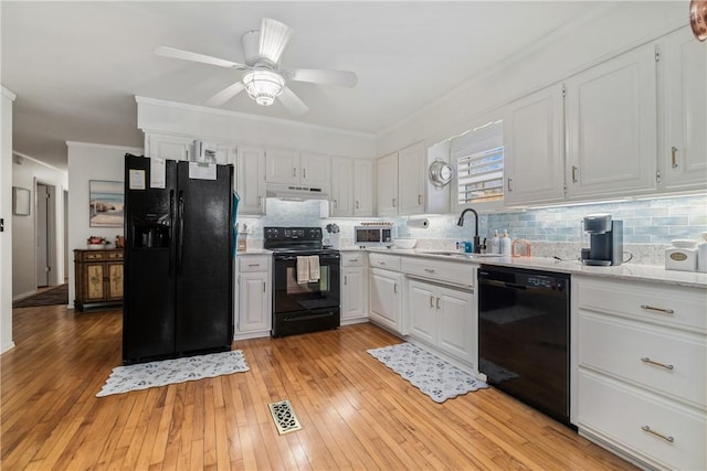 10230 S Marango Dr, Rogers, AR 72758 - kitchen featuring black appliances, a sink, crown molding, under cabinet range hood, and decorative backsplash