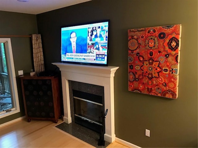 258B Vista, Mount Ida, AR 71957 - living room featuring baseboards, a fireplace with flush hearth, and wood finished floors