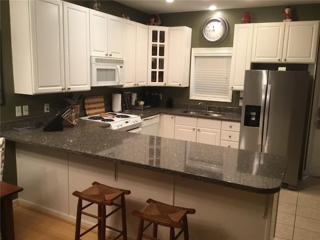 258B Vista, Mount Ida, AR 71957 - kitchen with white cabinets, white appliances, a peninsula, and a sink