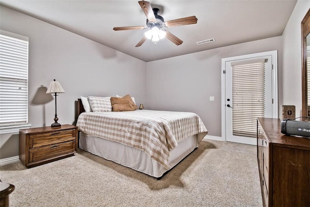 bedroom with a ceiling fan, baseboards, light colored carpet, and visible vents