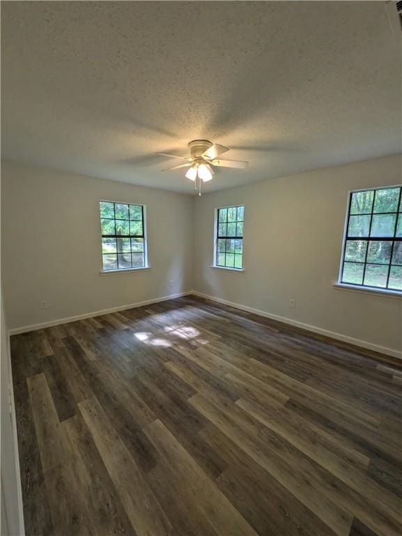 116 Stegall Rd, Clarksville, AR 72830 - empty room with a textured ceiling, dark wood finished floors, and ceiling fan