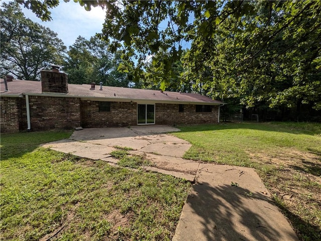 116 Stegall Rd, Clarksville, AR 72830 - back of property with a patio, brick siding, and a chimney