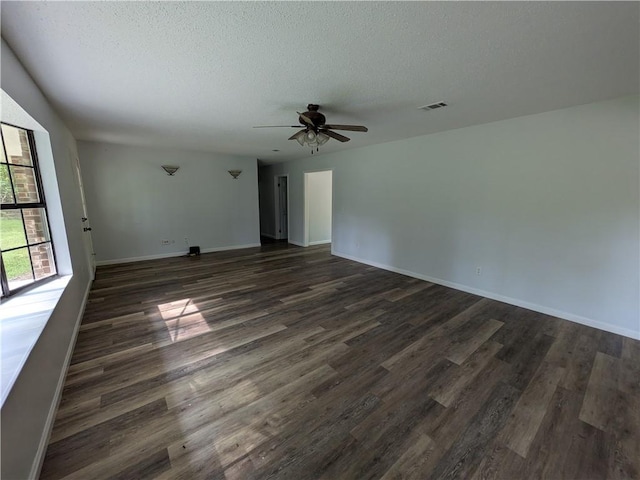 116 Stegall Rd, Clarksville, AR 72830 - spare room featuring a ceiling fan, dark wood-style flooring, and a textured ceiling