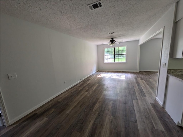 116 Stegall Rd, Clarksville, AR 72830 - unfurnished dining area featuring dark wood-style floors, a ceiling fan, and a textured ceiling