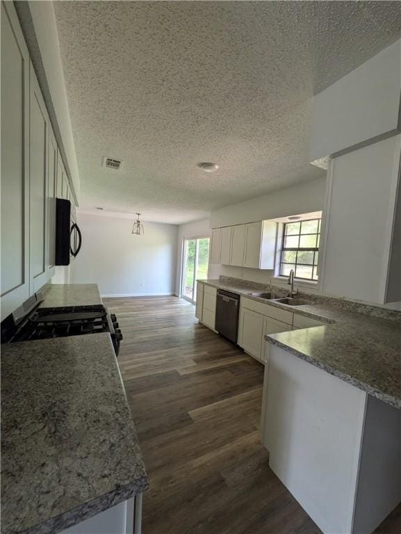 116 Stegall Rd, Clarksville, AR 72830 - kitchen featuring dishwasher, gas range, dark wood-style floors, black microwave, and white cabinetry