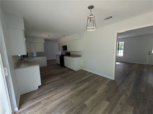 116 Stegall Rd, Clarksville, AR 72830 - kitchen featuring white cabinets, black appliances, dark wood-type flooring, open floor plan, and a textured ceiling