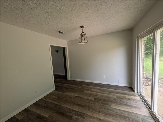 116 Stegall Rd, Clarksville, AR 72830 - unfurnished dining area featuring dark wood-style floors and a textured ceiling