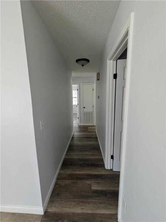 116 Stegall Rd, Clarksville, AR 72830 - corridor featuring a textured ceiling and wood finished floors