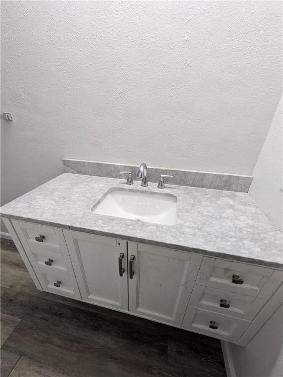 116 Stegall Rd, Clarksville, AR 72830 - bathroom with vanity, wood finished floors, and a textured wall