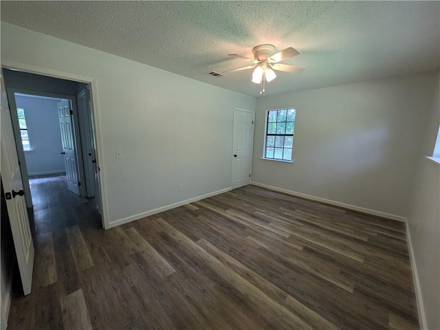 116 Stegall Rd, Clarksville, AR 72830 - empty room featuring dark wood finished floors, ceiling fan, and a textured ceiling