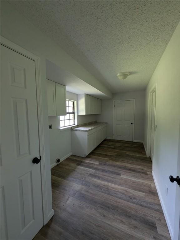 116 Stegall Rd, Clarksville, AR 72830 - washroom featuring cabinet space, a textured ceiling, hookup for an electric dryer, and dark wood-style floors
