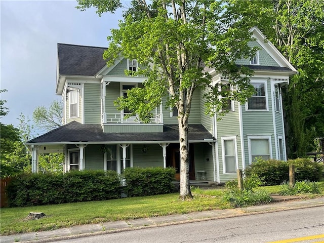 803 W Main St, Clarksville, AR 72830 - victorian house featuring covered porch and a shingled roof