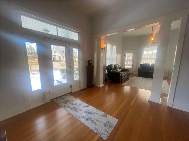 803 W Main St, Clarksville, AR 72830 - foyer entrance with wood finished floors and decorative columns
