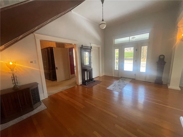 803 W Main St, Clarksville, AR 72830 - unfurnished living room featuring wood finished floors, baseboards, and a towering ceiling